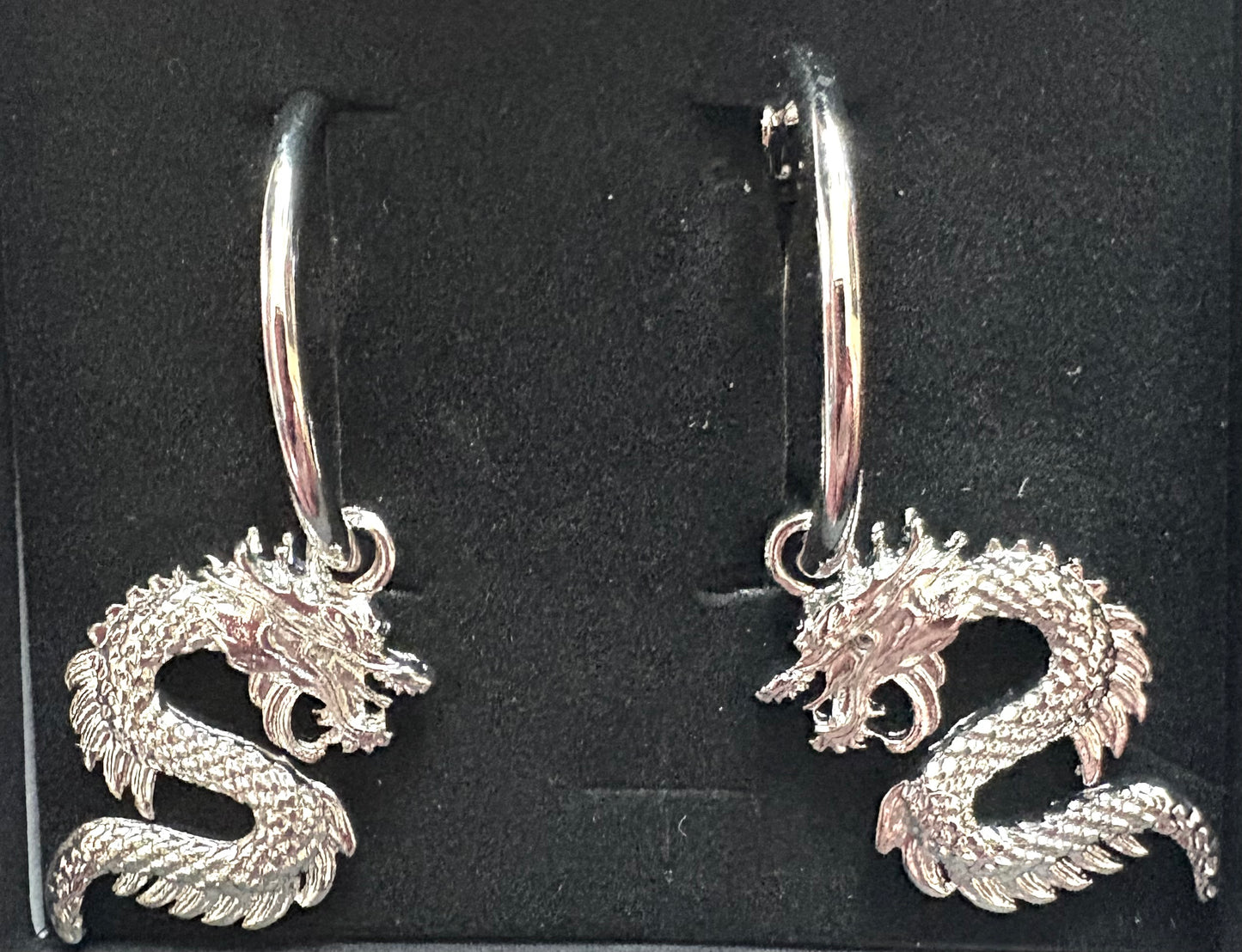 Dragon - pair of earrings. Silver coloured.